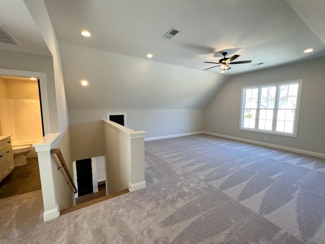 additional living space featuring carpet flooring, baseboards, a ceiling fan, and visible vents