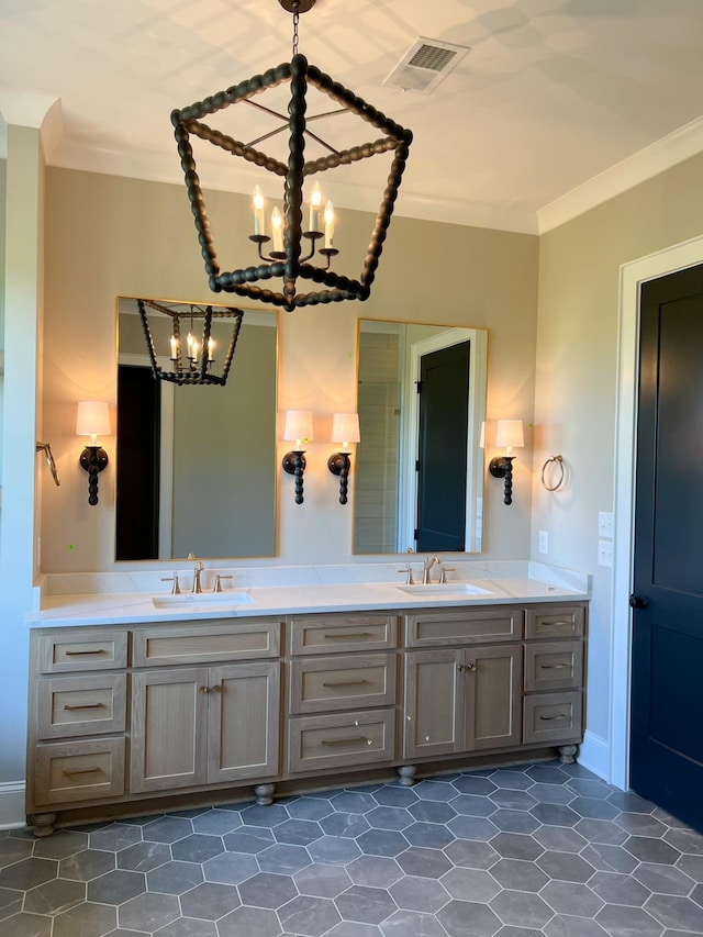 full bath featuring a sink, a notable chandelier, ornamental molding, and visible vents