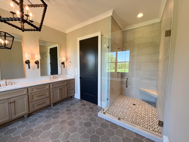 full bath featuring a sink, ornamental molding, a shower stall, and an inviting chandelier