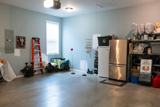 4769 Ellen Cir, Cookeville, TN 38501 - garage featuring a garage door opener, freestanding refrigerator, baseboards, and electric panel