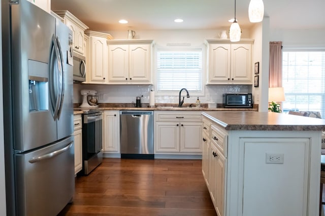 4769 Ellen Cir, Cookeville, TN 38501 - kitchen with a sink, pendant lighting, stainless steel appliances, decorative backsplash, and a kitchen island