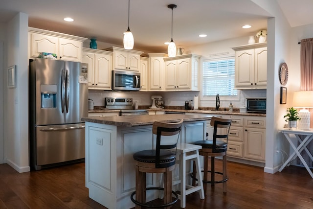 4769 Ellen Cir, Cookeville, TN 38501 - kitchen with appliances with stainless steel finishes, dark countertops, dark wood-style floors, and a kitchen island