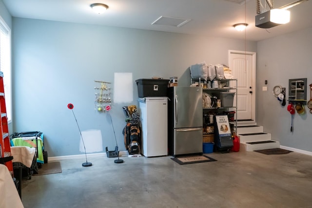 4769 Ellen Cir, Cookeville, TN 38501 - garage with baseboards, freestanding refrigerator, and a garage door opener