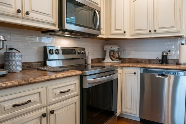 4769 Ellen Cir, Cookeville, TN 38501 - kitchen with dark countertops, decorative backsplash, and appliances with stainless steel finishes