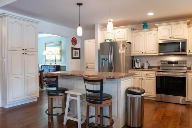 4769 Ellen Cir, Cookeville, TN 38501 - kitchen featuring dark wood-type flooring, a center island, appliances with stainless steel finishes, and a kitchen breakfast bar