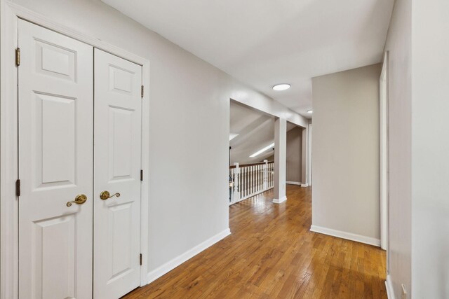 hallway with hardwood / wood-style flooring and baseboards