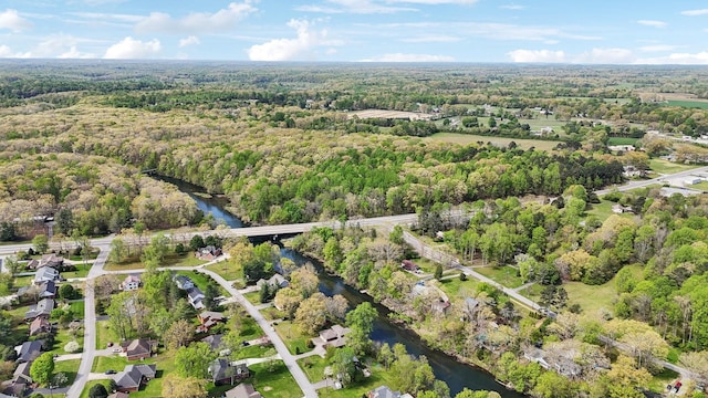 drone / aerial view featuring a view of trees and a water view