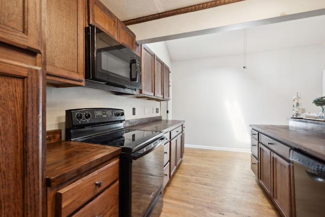 kitchen with light wood-type flooring, baseboards, black appliances, wood counters, and brown cabinetry