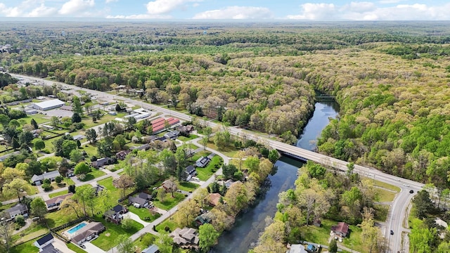 drone / aerial view featuring a view of trees and a water view