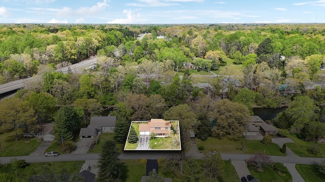 birds eye view of property with a view of trees