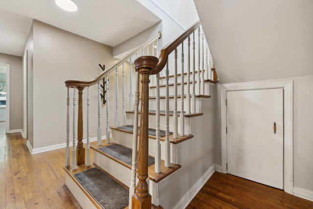stairs with wood-type flooring and baseboards