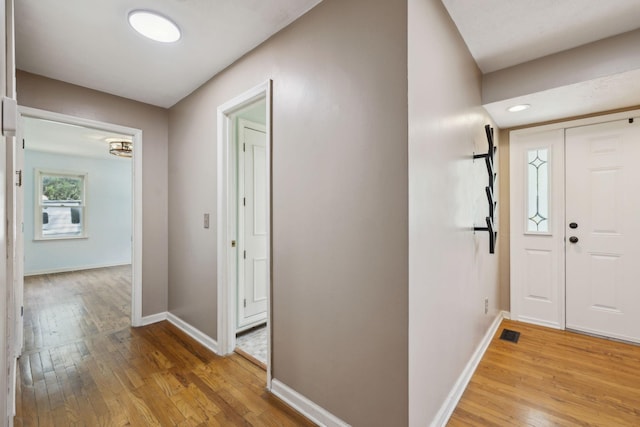 entrance foyer featuring visible vents, light wood-style flooring, and baseboards