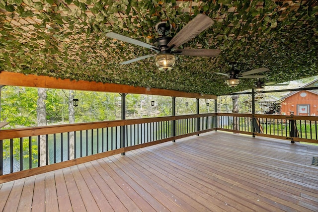 deck featuring a water view and a ceiling fan