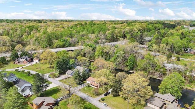 drone / aerial view with a wooded view