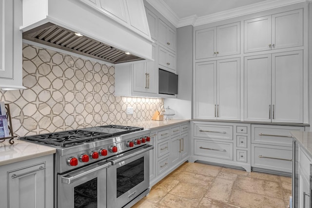 328 White Swans Xing, Brentwood, TN 37027 - kitchen with ornamental molding, light stone counters, premium range hood, range with two ovens, and stone tile flooring