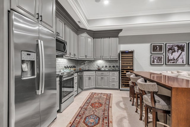 328 White Swans Xing, Brentwood, TN 37027 - kitchen with dark countertops, appliances with stainless steel finishes, gray cabinetry, decorative backsplash, and beverage cooler