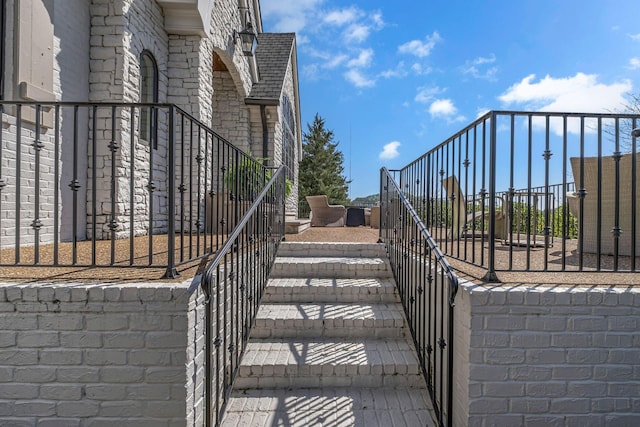 328 White Swans Xing, Brentwood, TN 37027 - view of home's exterior featuring fence, stone siding, a gate, and a shingled roof