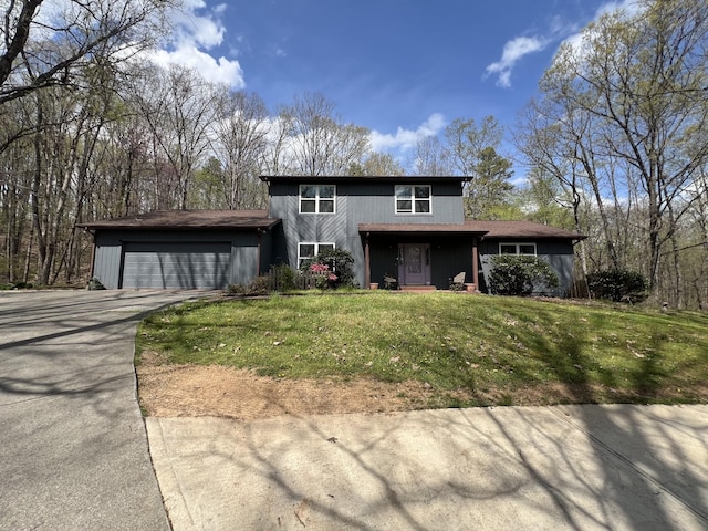 view of front of house with a front lawn, a garage, and concrete driveway