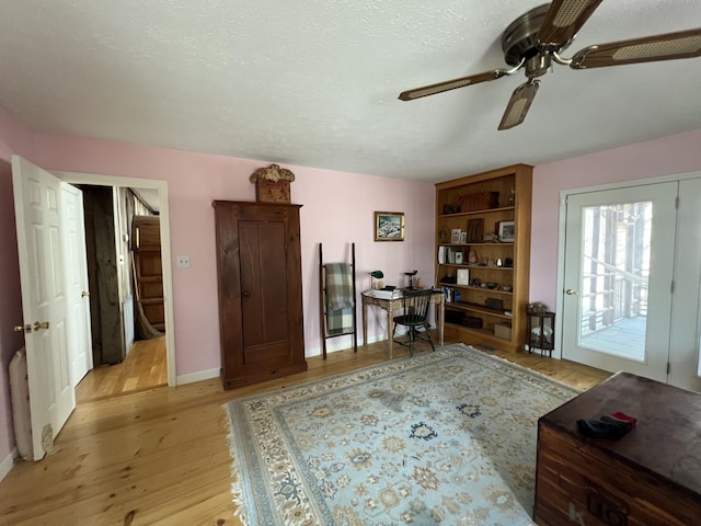 office with light wood-type flooring, baseboards, and ceiling fan