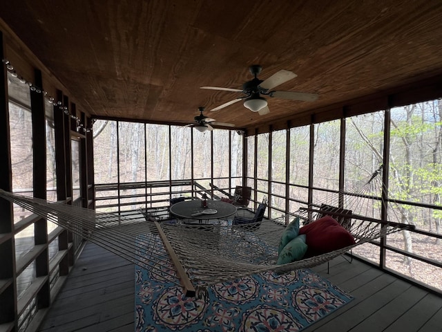 sunroom featuring a ceiling fan and a healthy amount of sunlight