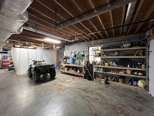 unfinished basement featuring concrete block wall