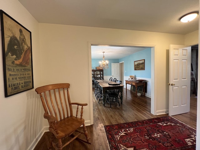 interior space featuring a chandelier, baseboards, and dark wood-type flooring