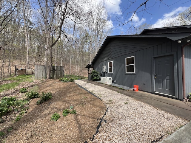 view of side of home with ac unit