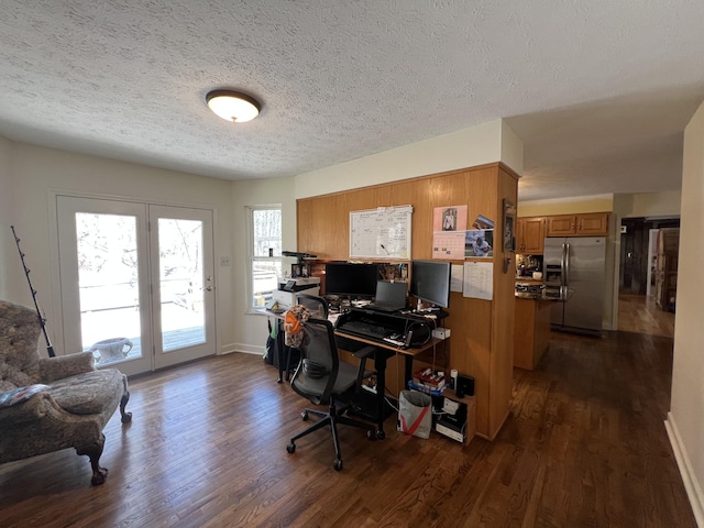 home office with dark wood-type flooring, a textured ceiling, and baseboards