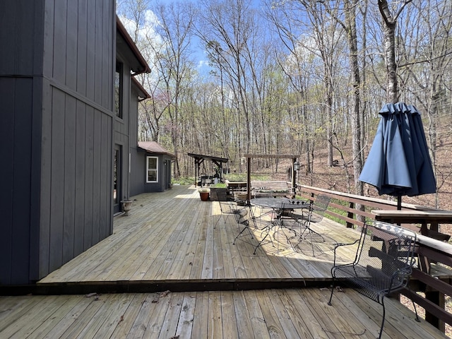 wooden deck featuring outdoor dining space