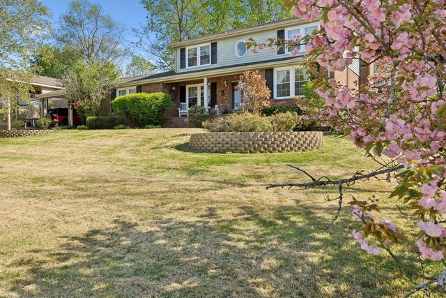 124 Timber Trail Dr, Lebanon, TN 37090 - traditional home featuring covered porch, brick siding, and a front yard