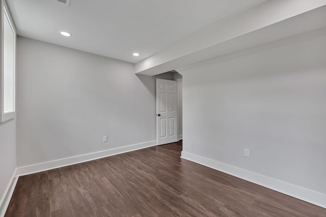 interior space featuring dark wood-style flooring, baseboards, and recessed lighting