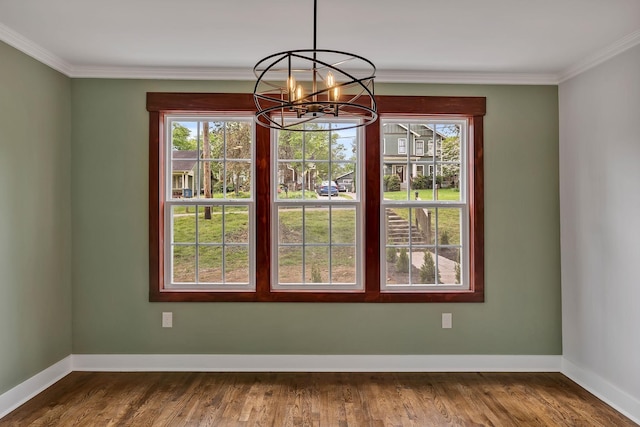 unfurnished dining area featuring ornamental molding, baseboards, a notable chandelier, and dark wood-style floors