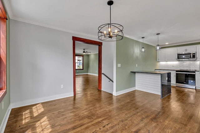 kitchen with tasteful backsplash, crown molding, baseboards, and stainless steel appliances