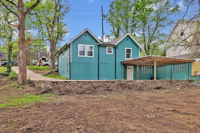 back of house featuring a pergola