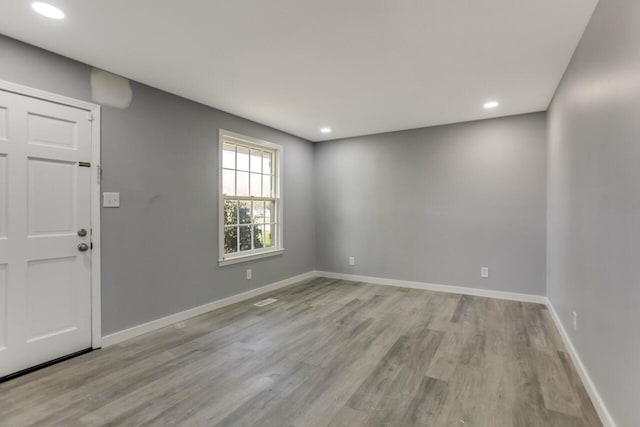 entrance foyer featuring baseboards, recessed lighting, and wood finished floors