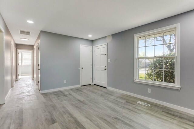 foyer featuring baseboards, visible vents, and plenty of natural light