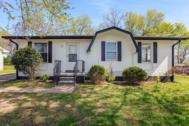 single story home with a front yard and brick siding