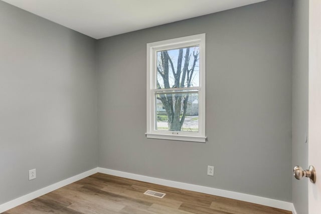 unfurnished room with visible vents, baseboards, and a healthy amount of sunlight
