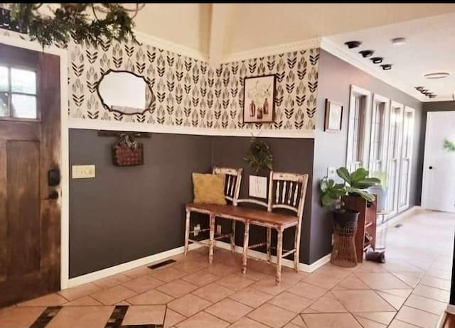 interior space featuring crown molding, visible vents, and tile patterned floors