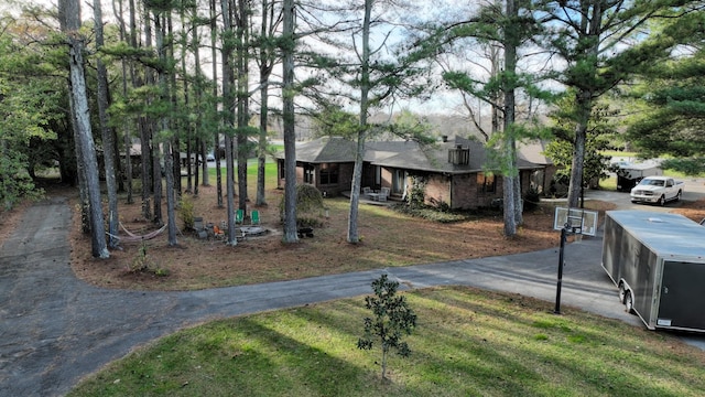 view of front of property featuring aphalt driveway and a front yard