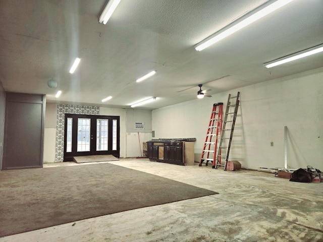 garage with french doors and a ceiling fan