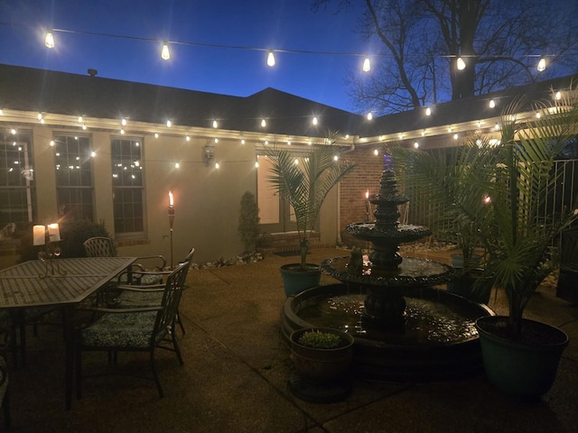 patio at night with outdoor dining area