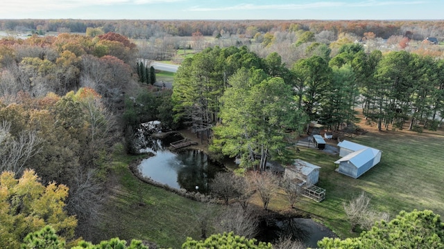 bird's eye view featuring a wooded view and a water view