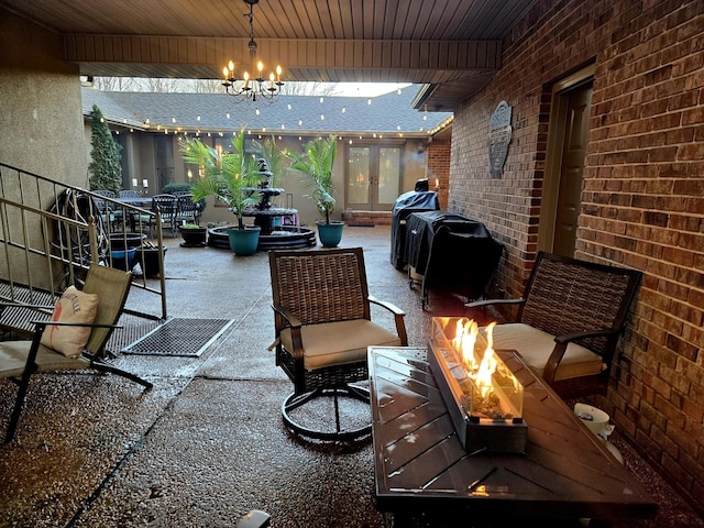 view of patio featuring a fire pit, french doors, and area for grilling