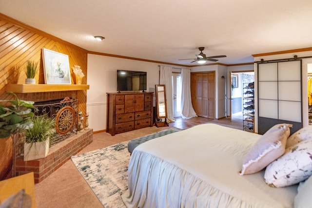 carpeted bedroom with crown molding, ceiling fan, baseboards, and wooden walls