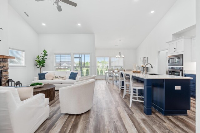 22 Flip Flop Ct, Winchester, TN 37398 - living room featuring recessed lighting, light wood-type flooring, high vaulted ceiling, and ceiling fan with notable chandelier