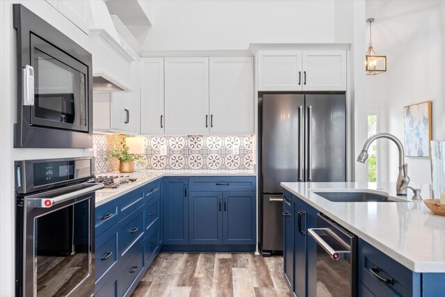 22 Flip Flop Ct, Winchester, TN 37398 - kitchen featuring blue cabinets, stainless steel appliances, a sink, and white cabinetry