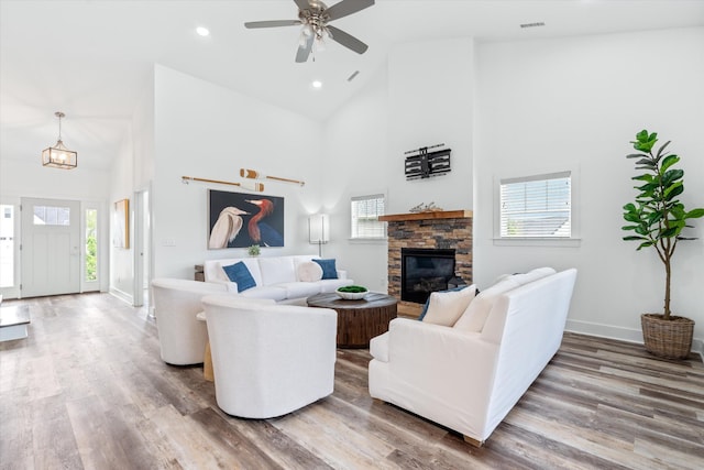 22 Flip Flop Ct, Winchester, TN 37398 - living area featuring high vaulted ceiling, a stone fireplace, wood finished floors, ceiling fan, and baseboards