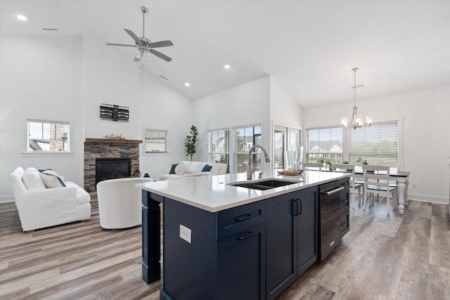 22 Flip Flop Ct, Winchester, TN 37398 - kitchen with high vaulted ceiling, a stone fireplace, a sink, ceiling fan with notable chandelier, and light countertops