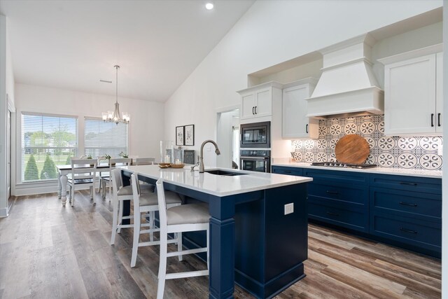 22 Flip Flop Ct, Winchester, TN 37398 - kitchen featuring a sink, black microwave, premium range hood, a notable chandelier, and wall oven